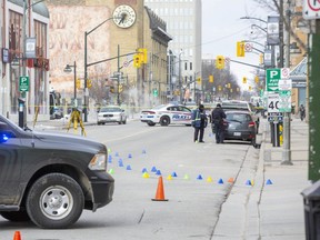 Police investigate after a woman was struck and killed by a vehicle on Clarence Street between York and King streets Friday morning in downtown London. (Derek Ruttan/The London Free Press)