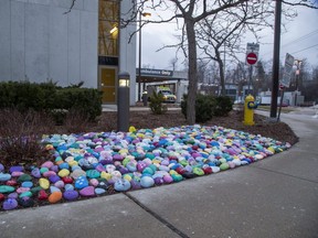 Hundreds of painted rocks featuring art work and words of encouragement have been placed in a garden outside of the University Hospital emergency department entrance in London. (Derek Ruttan/The London Free Press)