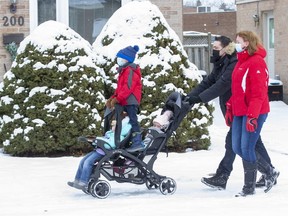 The Ensoll family, Michael, Heather, Andrew (5), Mackenzie (2) and Brooklyn (7 months) take a walk in London. (Derek Ruttan/The London Free Press)