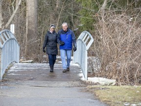 Cathie Gauthier and her husband Bob walk through the woods in  London's Hastings Park in London on Thursday January 21, 2021. (Derek Ruttan/The London Free Press)