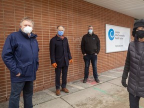 Former owners Jack Cox and Peter Whatmore join InterCommunity Health Centre's Scott Courtice and Goodwill chief Michelle Quintyn on Wednesday to mark the $1.45-million donation of 659 Dundas St. to  Goodwill. The agencies hope to create a $10-million health and community centre on the site. (Mike Hensen/The London Free Press)