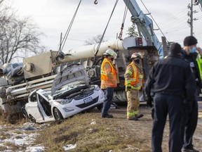 Two large tow trucks were called in to a collision at Bradley avenue and Jackson Road in the southeast corner of London to lift a semi off of a small sedan that it had partially crushed. (Mike Hensen/The London Free Press)