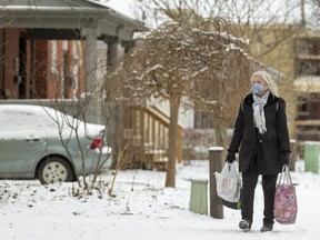 Karen Hansen carries a load of groceries home in Wortley Village in London. (Mike Hensen/The London Free Press)