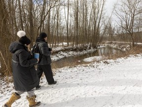 Kate Wiener and Pete Brown walk along Catfish Creek in the Yarmouth Natural Heritage Area south of Sparta, in this file photo. (Mike Hensen/The London Free Press)