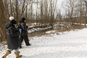 Kate Wiener and Pete Brown walk along Catfish Creek in the Yarmouth Natural Heritage Area south of Sparta, in this file photo. (Mike Hensen/The London Free Press)