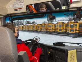 Helena Heuving, a school bus driver for 16 years and a dispatcher for four, moves a school bus Friday, Jan. 29, 2021 at the Elgie Bus Lines Ltd. Sovereign Road site. 
Cathy Van Bommel, a manager at Elgie, said they've been keeping their buses and drivers ready to go, so they will be ready for Monday's school re-opening.
Van Bommel said drivers have been coming in weekly to drive their buses, and perform checks because they had to be ready to operate as soon as they got word from the government.  (Mike Hensen/The London Free Press)