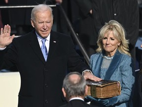 Joe Biden is sworn in as the 46th president of the United States by Chief Justice John Roberts as Jill Biden holds the Bible during the 59th Presidential Inauguration at the U.S. Capitol in Washington on Jan. 20, 2021.
(Saul Loeb/Pool Photo via AP)