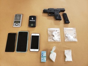 London police seized a loaded 9mm handgun, ammunition, suspected drugs, cellphones, cash and digital scales during the search of a home and vehicle on Thursday, police said.  (Police supplied photo)