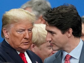 U.S. President Donald Trump talks with Canada's Prime Minister Justin Trudeau on December 4, 2019, during a North Atlantic Treaty Organization Plenary Session at the NATO summit in Watford, Britain.