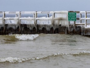 Water freezes along the sides of a pier on Lake Huron on Thursday, Dec. 17, 2020, in Alpena, Mich. MUST CREDIT: photo for The Washington Post by Elaine Cromie.