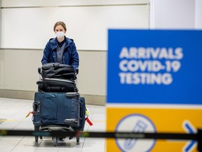 A passenger arrives at Toronto's Pearson airport after mandatory coronavirus disease (COVID-19) testing took effect for international arrivals in Mississauga, Ontario. REUTERS/Carlos Osorio/File Photo