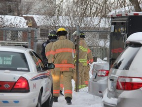 Fire officials investigate a townhouse on Arbour Glen Crescent in northeast London following a fire Feb. 17 that killed a man and his dog. London police said Monday foul play is not suspected in the death of the man, identified by friends and family as William Michael Cornish. (JONATHAN JUHA/The London Free Press)