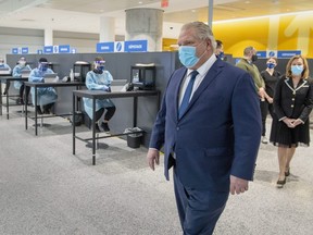 Ontario Premier Doug Ford visits the COVID-19 test centre at Toronto's Pearson Airport, which becomes one of only four landing points for international flights to Canada on Thursday, Feb. 4 (Canadian Press file)