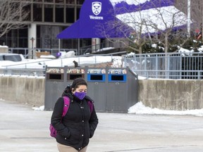 Biomedical engineering grad student Monica Vasquez walks through the Western University campus in London on Friday. Western students are being encouraged to get a COVID-19 test before returning to residences. (Derek Ruttan/The London Free Press)