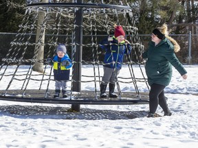 Melissa Sherman spins her sons Isaac (5) and Finley (2) on the carousel at Pinafore Park in St. Thomas on Sunday. "We're trying to get our energy out," quipped Isaac. (Derek Ruttan/The London Free Press)