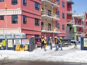 Workers were allowed back onto the construction site at 555 Teeple Terrace Wednesday. The four-storey building partly collapsed Dec. 11, killing two men and injuring five others. (Derek Ruttan/The London Free Press)