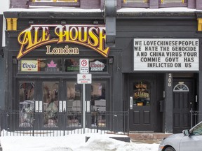 The owner of the Ale House on Dundas Street in downtown London often use its sign to express its opinion. One that referenced the "China virus" drew community backlash, and was replaced Thursday by this one, which included the same phrase. (Derek Ruttan/The London Free Press)