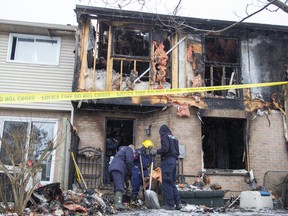 London police help members of the Ontario Fire Marshal's office investigate a weekend fire at an east-end townhouse complex on Admiral Drive near Bonaventure Drive in London. Photo taken on Sunday February 28, 2021. Derek Ruttan/The London Free Press/Postmedia Network