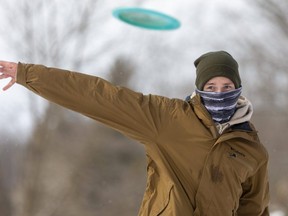 Jordan Cseszneki of London concentrates as he goes for a long shot during a round of disc golf in St. Thomas on Tuesday. Cseszneki, who's been playing disc golf for about five years, says the courses are fairly busy in the winter, too, because the sport can be played in all seasons. (Mike Hensen/The London Free Press)