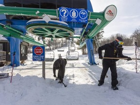 Matt Orr and Dylan Fidler shovel the approach to a chair lift at Boler Mountain. The Byron ski hill will open for the first time this winter on Tuesday. It will operate with extended hours, but at 50 per cent capacity because of COVID-19 restrictions.
Mike Hensen/The London Free Press