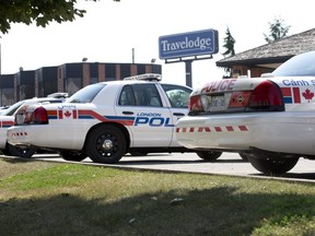 London police cruisers were parked at the Exeter Road Travelodge hotel in London on Sept. 10, 2013, as officers investigated the death of Alex Fraser, 20. James McCullough of Orangeville was convicted in 2016 of first-degree murder in Fraser's death and is serving a life sentence with no chance of parole for 25 years. (File photo)