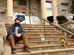 St. Marys Mayor Al Strathdee sits on the steps of the St. Marys Public Library, where the town has set up a temporary memorial for the victims of the COVID-19 pandemic (Galen Simmons/The Beacon Herald)