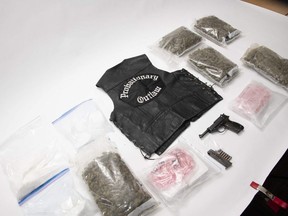 OPP officers seized 31 firearms, 81 grenades, an Outlaws vest and illegal cannabis in searches earlier this month as part of a probe into the trafficking of guns and weapons in Southwestern Ontario. A 35-year-old London man faces several drug charges following the seizure in London of $1.8 million of illegal cannabis and cannabis products in London, OPP said Thursday. (SUPPLIED)