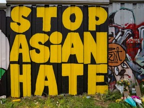 Members of the Bad Asian and Civic Walls groups paint a mural near Krog Street Tunnel on March 21, 2021 in Atlanta, Ga. The murals are in remembrance of the eight lives lost at the three spa shootings in Atlanta this past week. (Megan Varner/Getty Images)