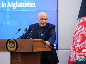 This handout photograph taken on February 23, 2021 and released by the Press Office of President of Afghanistan shows Afghan President Ashraf Ghani speaking during a ceremony at the Presidential Palace in Kabul, as Afghanistan launched a Covid-19 vaccination campaign. (Photo by - / Press Office of President of Afghanistan / AFP)