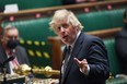 A handout photograph released by the UK Parliament shows Britain's Prime Minister Boris Johnson attending Prime Minister's Questions (PMQs) in a socially distanced, hybrid session at the House of Commons, in central London on March 24, 2021. (Photo by JESSICA TAYLOR / various sources / AFP)