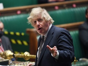 A handout photograph released by the UK Parliament shows Britain's Prime Minister Boris Johnson attending Prime Minister's Questions (PMQs) in a socially distanced, hybrid session at the House of Commons, in central London on March 24, 2021. (Photo by JESSICA TAYLOR / various sources / AFP)
