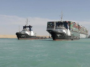 A picture released by Egypt's Suez Canal Authority on March 29, 2021, shows a tugboat pulling the Panama-flagged MV 'Ever Given' container ship after it was fully dislodged from the banks of the Suez. - The ship was refloated and the Suez Canal reopened, sparking relief almost a week after the huge container ship got stuck and blocked a major artery for global trade. Salvage crews have been working around the clock ever since the accident which has been blamed on high winds and poor visibility during a sandstorm. (Photo by - / SUEZ CANAL AUTHORITY / AFP) (Photo by -/SUEZ CANAL AUTHORITY/AFP via Getty Images)