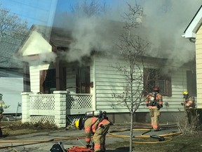 London firefighters clean up Friday afternoon and look for remaining pockets of fire at a house on Sterling Street in the east end. No one was injured in the blaze that started at about 3:30 p.m. (London fire department Twitter)