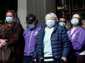 Victims, as well as family and friends of victims of the 2018 deadly van attack gather outside the Toronto Courthouse in Toronto as crown attorney Joe Callaghan reads a statement to media following the verdict in the trial of Alek Minassian, on Wednesday, March 3, 2021.