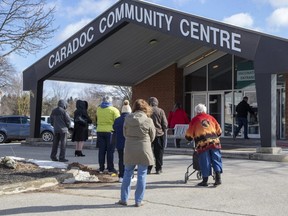 People line up outside the vaccination clinic at Caradoc Community Centre in Mt. Brydges on Friday. The clinic was part of the milestone Thursday when Middlesex-London hit a record number of vaccinations in a day at 1,900. (Derek Ruttan/The London Free Press)