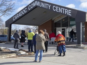 People line up outside the vaccination clinic at Caradoc Community Centre in Mt. Brydges. (Derek Ruttan/The London Free Press)