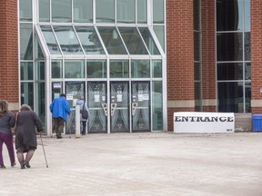 People enter the COVID-19 vaccination clinic at the Agriplex in London, Ont. on Monday March 8, 2021. (Derek Ruttan/The London Free Press)