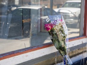 Flowers were placed near the entrance to an apartment a fire one day prior killed April Calcutt, 38, in West Lorne. Photo taken March 10, 2021. (Derek Ruttan/The London Free Press)