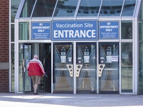 People enter the COVID-19 vaccination clinic at the Western Fair District Agriplex in London on Monday March 22, 2021. (Derek Ruttan/The London Free Press)