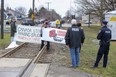 Demonstrators protesting the sale of London-made armoured vehicles to Saudi Arabia occupy the CN Rail tracks at Clarke Road and Oxford Street in London on Friday, March 26, 2021. The line near the General Dynamics Land Systems Canada plant was blocked for about two hours before the demonstrators left at about 1 p.m. (Derek Ruttan/The London Free Press)