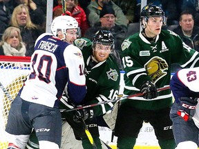 Jordan Frasca, left, of the Windsor Spitfires battles with Kevin Hancock and Cole Tymkin of the London Knights in front of Spitfires goalie Kari Piiroinen at Budweiser Gardens on Friday January 25, 2019 in London. (London Free Press file photo)