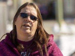 Kim Taylor talks about gunshots that left a bullet hole in her daughter's bedroom window at their Walker Street before dawn on Tuesday. (Mike Hensen/The London Free Press)