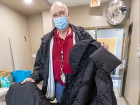 Jon DeActis, executive director of the Salvation Army's Centre of Hope, holds a donated Empwr coat that doubles as a sleeping bag. The centre has given away 13 of the 15 coats it received to people living outside. Photograph taken on Thursday March 18, 2021. (Mike Hensen/The London Free Press)