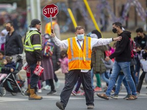 Dennis Gignac, a crossing guard at Eagle Heights public school on Oxford Street, oversees one of the busiest crossings in London when the Thames Valley District school board's largest elementary school lets out at day's end. He was given gifts from teachers and parents this week on Ontario's School Crossing Guard Appreciation Day. Photograph taken on Wednesday March 24, 2021.  (Mike Hensen/The London Free Press)