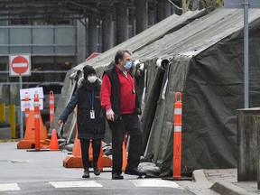 Employees of the Public Health Agency of Canada stand outside a tent erected to perform the coronavirus disease (COVID-19) molecular test at one of five initial entry points at the Douglas border crossing in Surrey, British Columbia, February 22, 2021.