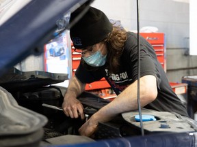 Corey Sheldon works repairing a vehicle at Hillman's Auto Centre on Springbank Drive. Workers such as mechanics are considered essential and will not impacted by Ontario's third stay-at-home order. JONATHAN JUHA/The London Free Press