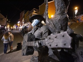 The statue of iconic singer-songwriter Ron Hynes in downtown St. John’s, NL, is adorned with a mask. Newfoundland and Labrador, along with the other Atlantic provinces of Nova Scotia, New Brunswick and Prince Edward Island have had the greatest success in Canada in keeping COVID-19 under control. (Paul Daly/The Canadian Press)