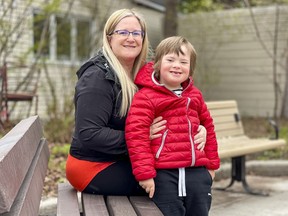 Anabel Lindblad sits with her son, Théo, who is unable to do at-home remote learning.