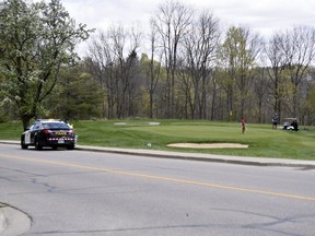 Oxford OPP officers were at the Bridges in Tillsonburg golf course Friday, taking notes and snapping photos of golfers. The golf course was charged Thursday night under the Reopening Ontario Act for violating the province's lockdown orders. (KATHLEEN SAYLORS/Postmedia Network)