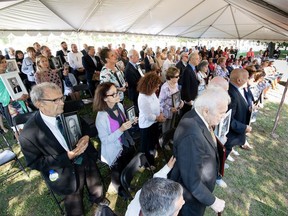 Children and grandchildren of Italian Canadians interned during the Second World War hold their family members' portraits Sept. 18, 2018 at a ceremony in Ottawa marking the RCMP's issuing of a Statement of Regret for the force's participation in the internment. Credit: Serge Gouin, Courtesy of RCMP